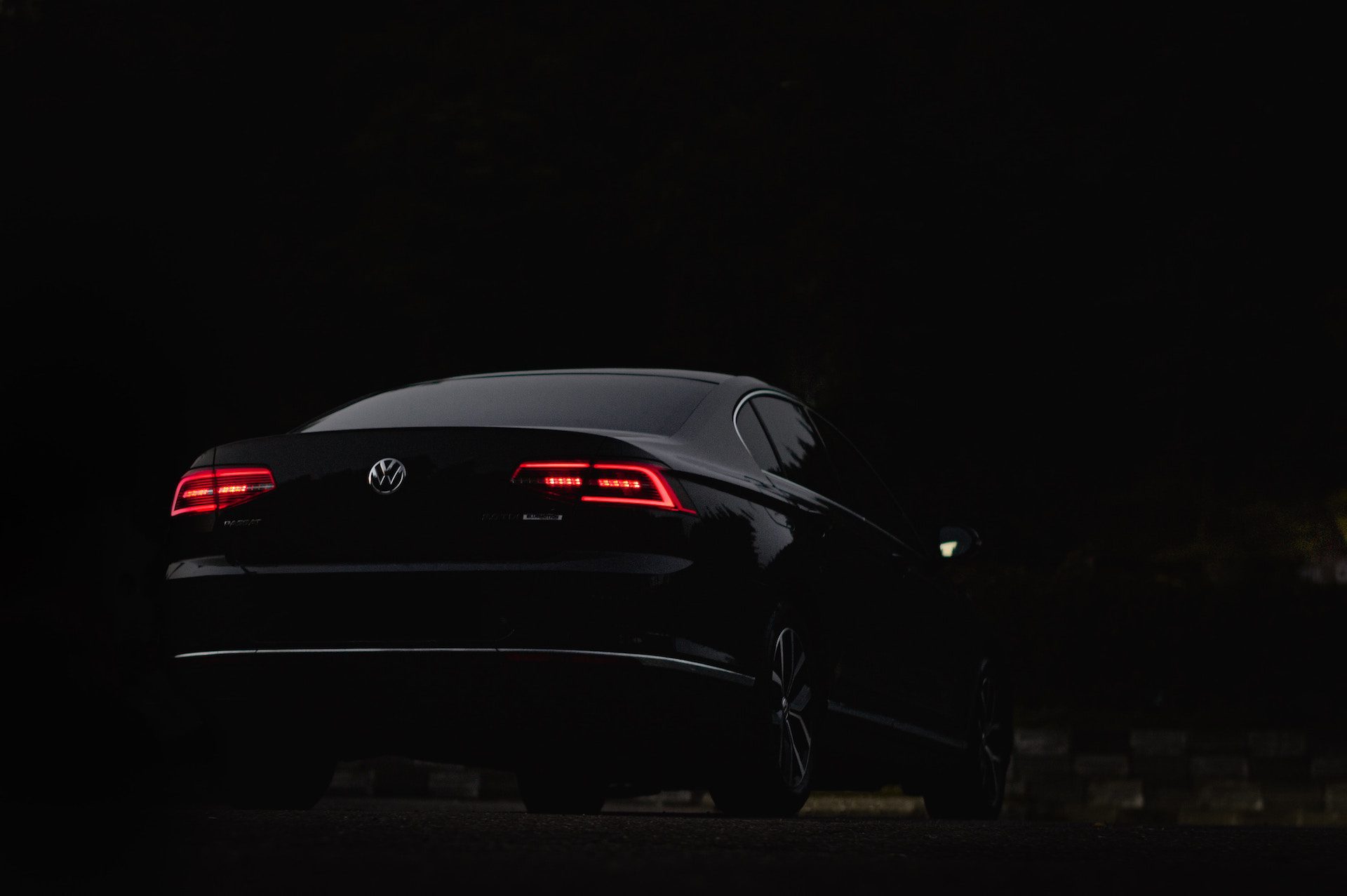 Shot of the back of a black Volkswagen car at night