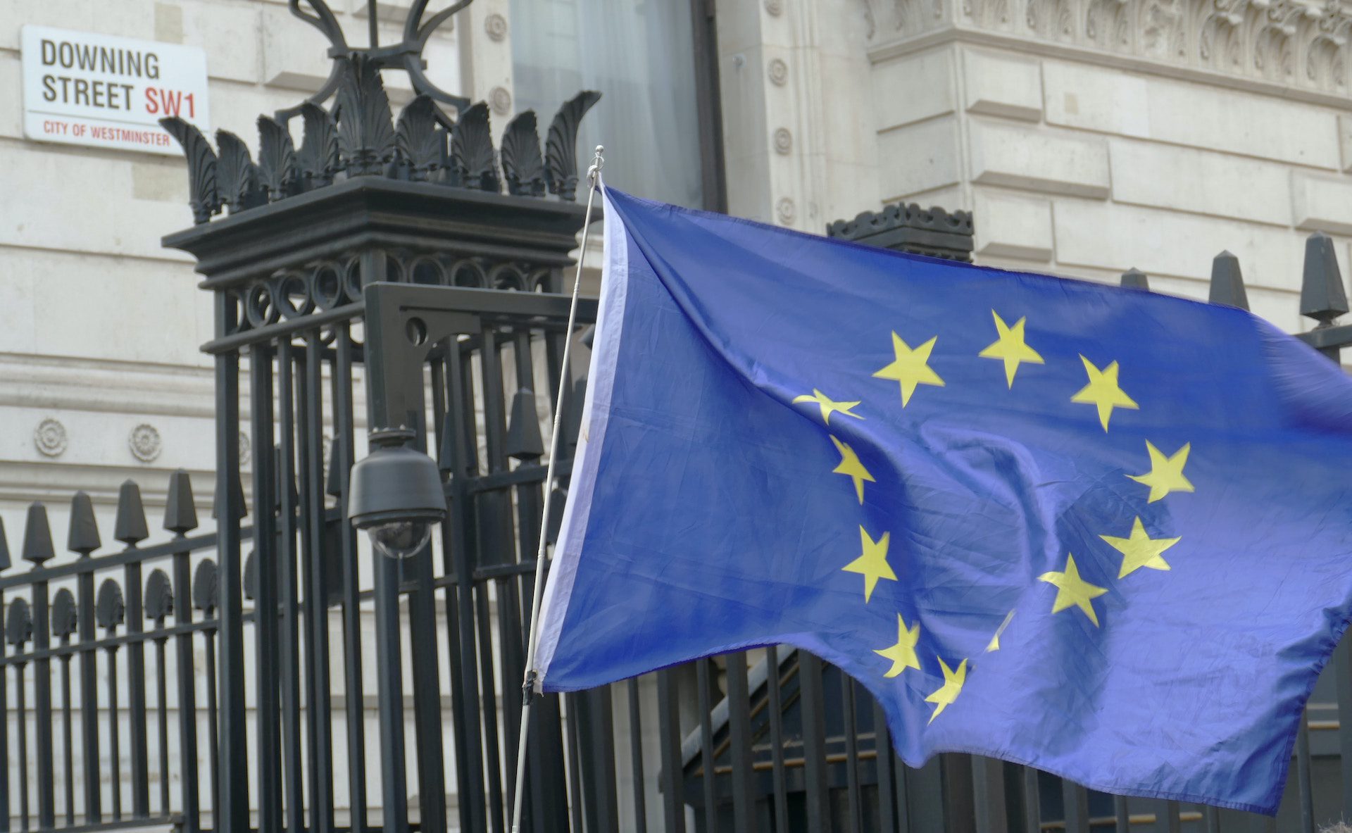 European flag in front of a Downing street road sign