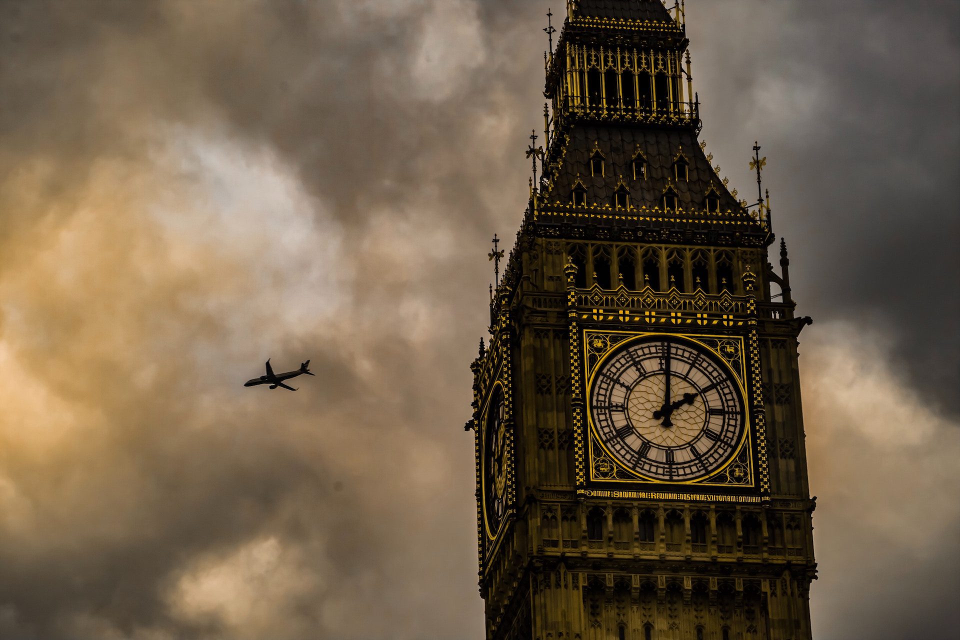 close up of Big Ben, London with an aeroplane in the background