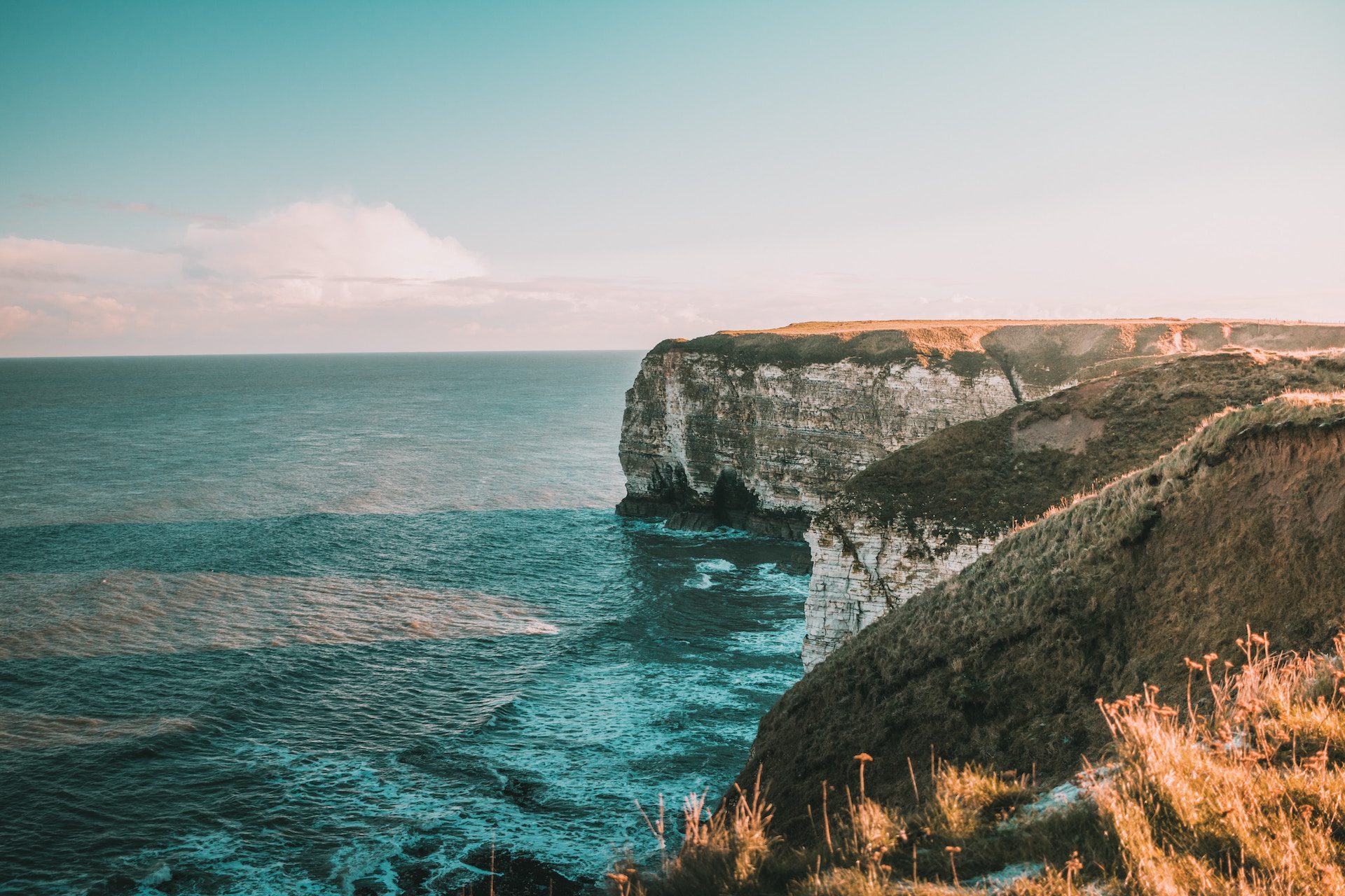 sea with cliff tops and grass