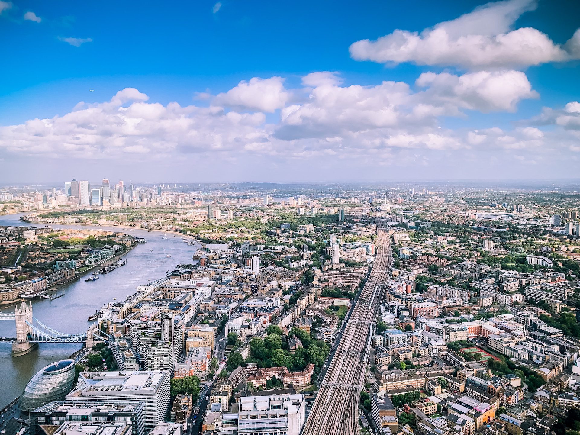 birds eye view of a city with water against a blue sky background