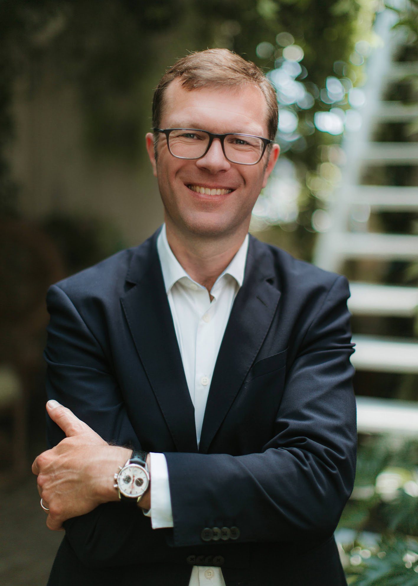 a man in a suit with his arms crossed